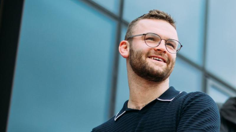 male student looking sideways and smiling